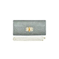 silver straw clutch bag with a bamboo clasp and chain strap on a white background