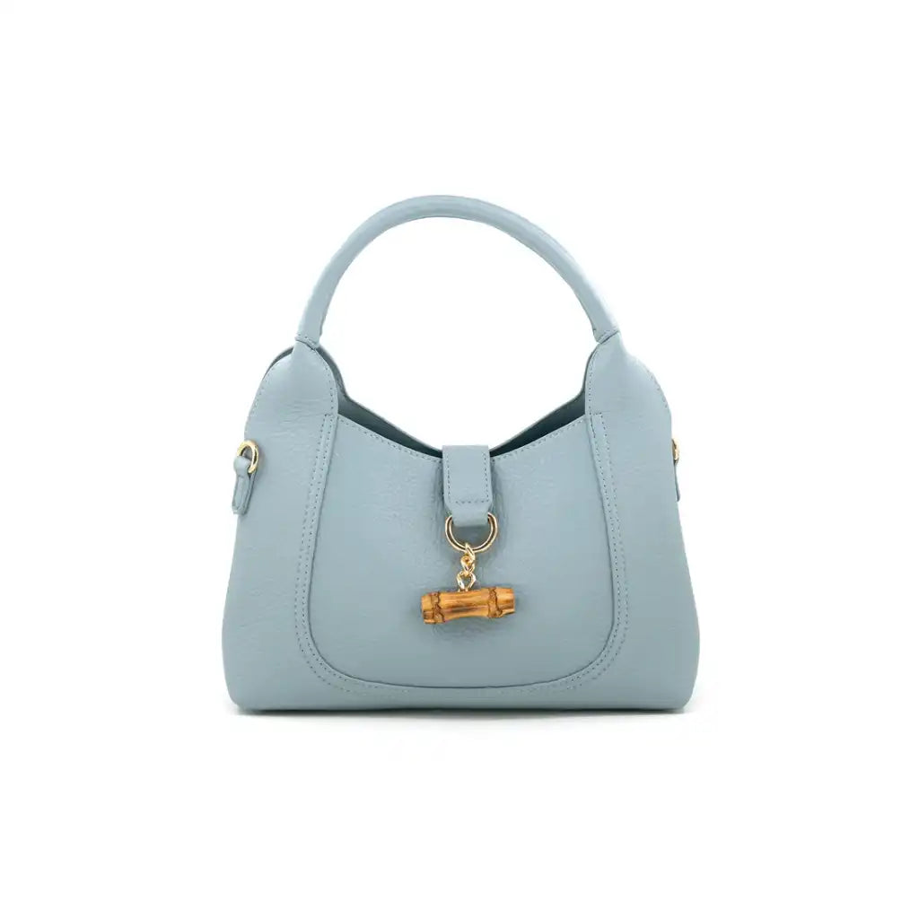 milan Light blue vegan leather handbag with a bamboo buckle on a white background