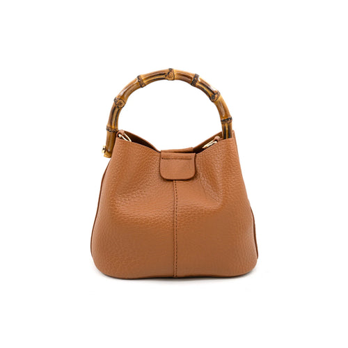 A tan pebbled leather handbag with a distinctive curved bamboo handle, shown against a plain white background.