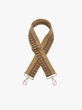 A woven crossbody bag strap with an aztec pattern in beige, brown, and mustard, featuring gold-tone metal hardware and snap hooks at both ends, displayed on a clean white background.