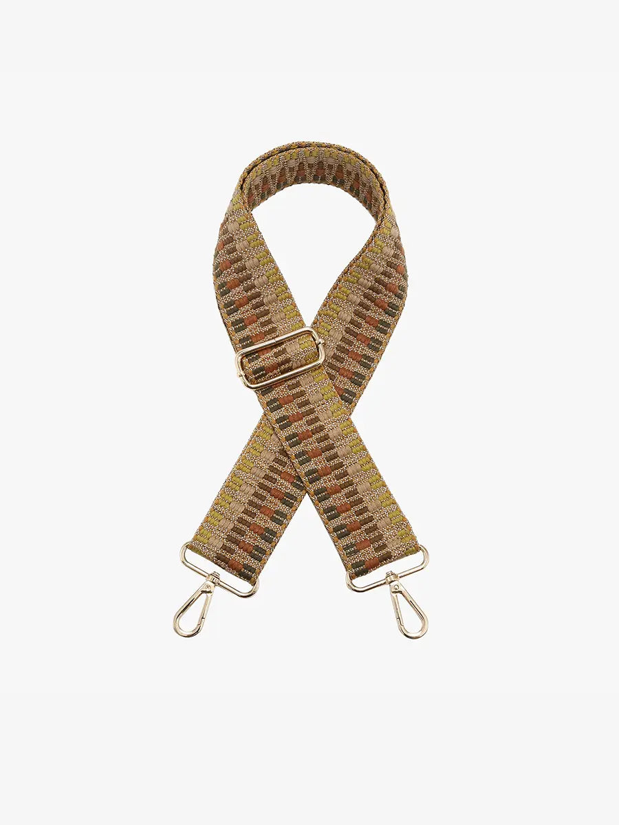 A woven crossbody bag strap with an aztec pattern in beige, brown, and mustard, featuring gold-tone metal hardware and snap hooks at both ends, displayed on a clean white background.