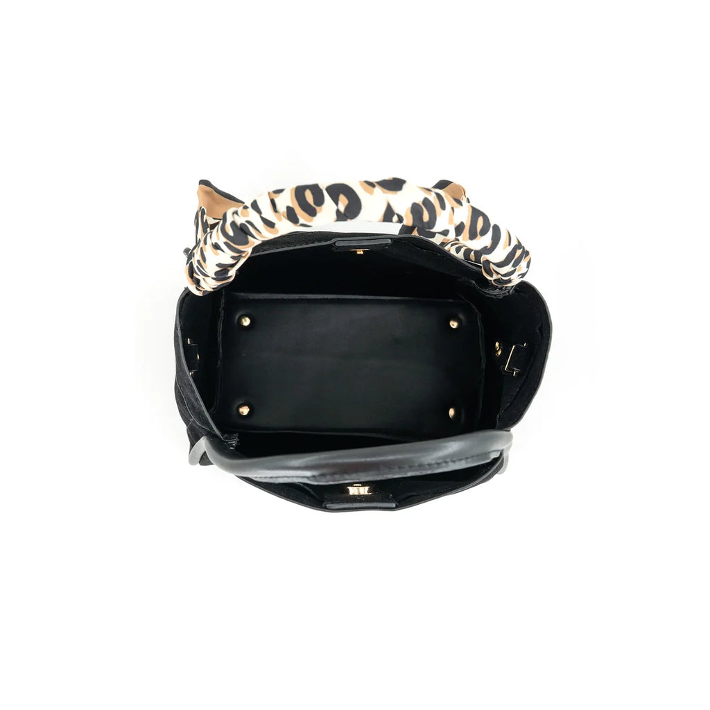 An open black handbag with a leopard-print fabric handle, photographed from a top-down view on a white background.